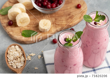 Homemade yogurt smoothie with banana, cranberry and oatmeal 73820206