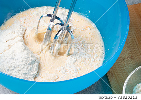 Kneading baking dough with an electric mixer 73820213