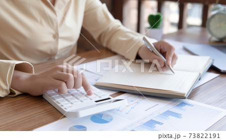 Head of accounting is recording the company's financial growth statistics using graphs as a reference for reviewing and analyzing the results, Taking notes and analyzing data graphs in office. Head of accounting is recording the company's financial growth statistics using graphs as a reference for reviewing and analyzing the results, Taking notes and analyzing data graphs in office. 73822191