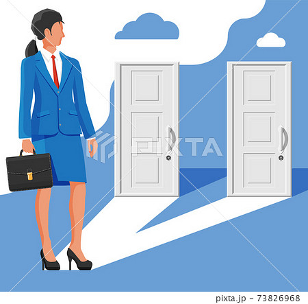 Businesswoman standing in front of two doors 73826968