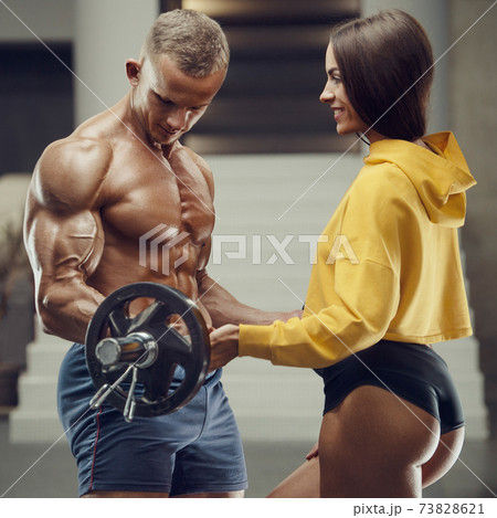 Sporty fitness couple working out in gym Sporty fitness couple working out in gym 73828621
