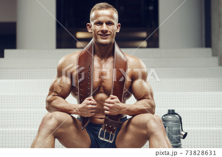 Bodybuilder drinking water after fitness workout Bodybuilder drinking water after fitness workout 73828631