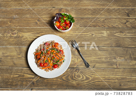 Salad with buckwheat and vegetables on a white plate Salad with buckwheat and vegetables on a white plate 73828783