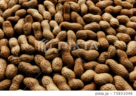Heap of raw peanuts on the table 73831046