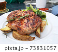 Grilled steaks, baked potatoes. herbs and vegetables,Prague. 73831057