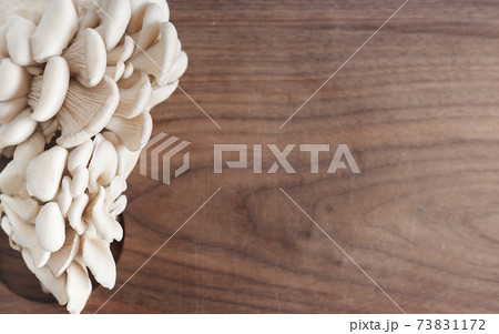 fresh grown oyster mushrooms on a kitchen cut board. fresh grown oyster mushrooms on a kitchen cut board. 73831172