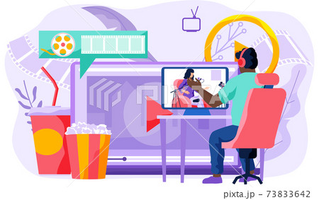 The guy in the headphones looks at the singing girl on the monitor. Online cinema concept The guy in the headphones looks at the singing girl on the monitor. Online cinema concept 73833642