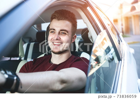 Close up side portrait of happy caucasian man driving car. Close up side portrait of happy caucasian man driving car. 73836059