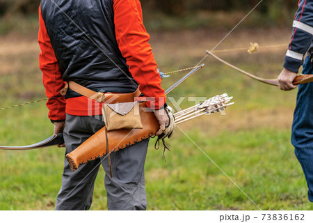 Archer with Leather Quiver with Arrows and Wooden Bow - Archery sport Longbow 73836162
