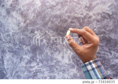 top view of man hand holding pills with copy space top view of man hand holding pills with copy space 73838035