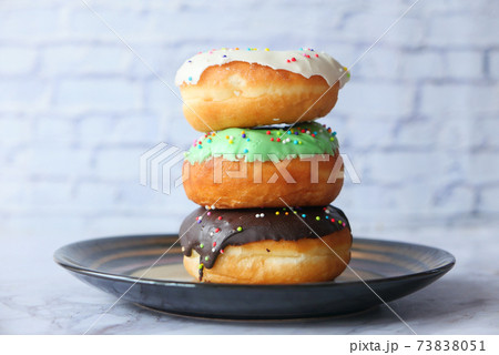 close up of colorful homemade donuts on plate  73838051