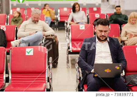 People sitting in terminal airport People sitting in terminal airport 73839771