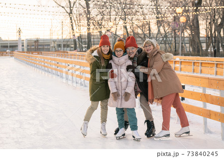 Happy family on ice rink Happy family on ice rink 73840245