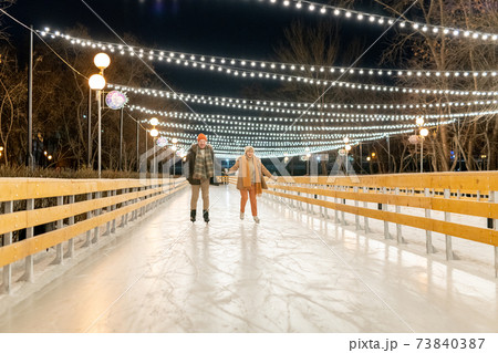 Mature couple skating outdoors 73840387