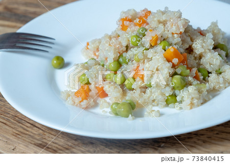 Quinoa porridge with vegetables and avocado in a white flat plate on a 73840415