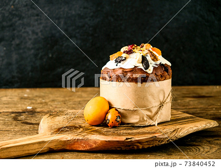 Easter cake and eggs on a wooden board. Still life on a black Easter cake and eggs on a wooden board. Still life on a black 73840452