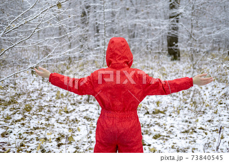 A faceless Caucasian teenage girl in a red overalls stands against the A faceless Caucasian teenage girl in a red overalls stands against the 73840545