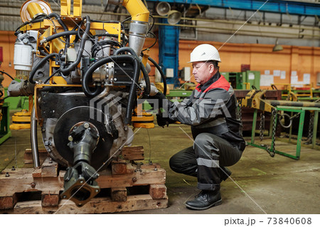 Worker in factory on the machine Worker in factory on the machine 73840608