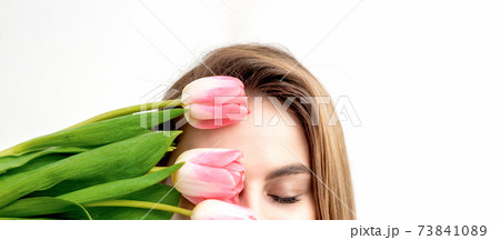 Young woman with pink tulips 73841089