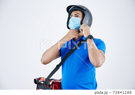 Develiry man putting on helmet 73841289