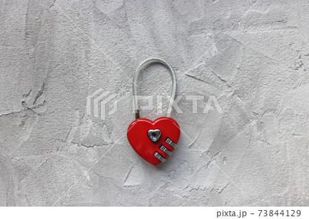 Red padlock or love lock on gray background, heart shaped Red padlock or love lock on gray background, heart shaped 73844129
