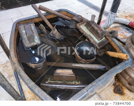 Metal table with water pool, wet wooden forms and glass scissors Metal table with water pool, wet wooden forms and glass scissors 73844700