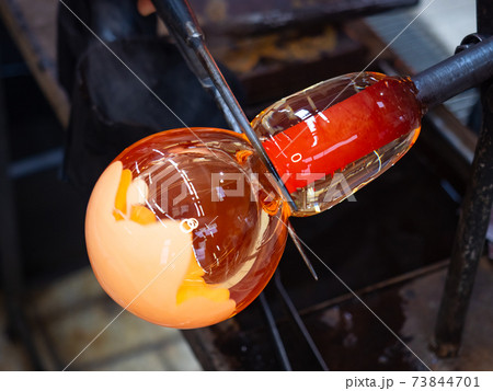 Glassworks glass manufacturing. Manual process of forming a decorative vase Glassworks glass manufacturing. Manual process of forming a decorative vase 73844701