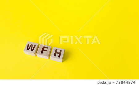 Blocks with WFH (work from home) abbreviation. New normal. Strict requirements and restrictions policies in the work of company. Organization staff teleworking. Revision of basic business approaches 73844874