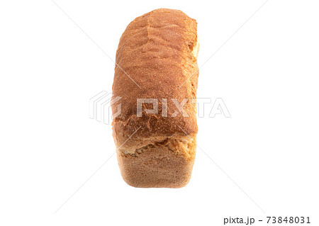 Whole loaf of wheat bread on a white plate. Whole loaf of wheat bread on a white plate. 73848031