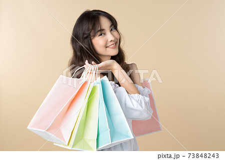 Young Asian woman holding shopping bag Young Asian woman holding shopping bag 73848243