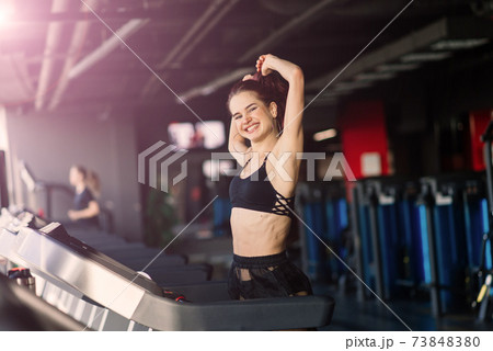 Young woman exercise fitness and workout while run on track in sport club 73848380