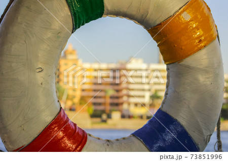 old lifebuoy hanging on the building background 73851996