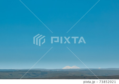 double peak of Elbrus in the distance against the blue sky. Russia, Caucasus double peak of Elbrus in the distance against the blue sky. Russia, Caucasus 73852021