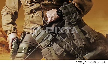 Soldier in military outfit with bulletproof vest. 73852621