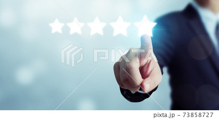 Businessman pointing five star symbol to increase rating of company 73858727