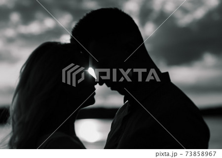Loving couple kissing on the nature, summer evening 73858967