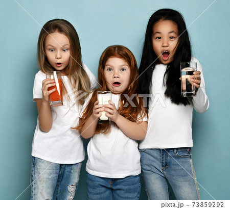 Three socked kids girls friends in white t-shirts Three socked kids girls friends in white t-shirts 73859292
