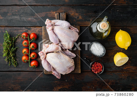 Whole raw free range chicken with ingredients, on old wooden table, top view 73860280
