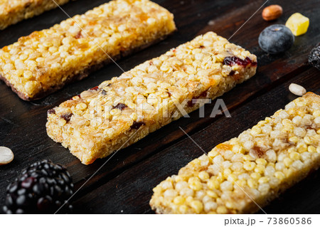 Granola bar with raisins, on wooden table 73860586