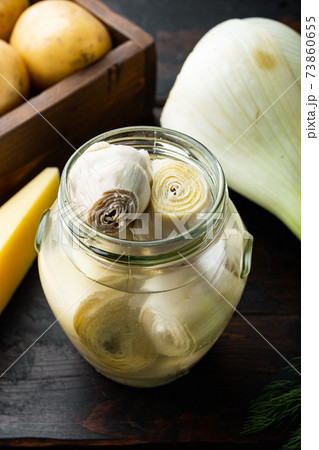 Artichoke hearts marinated in olive oil, on old wooden table Artichoke hearts marinated in olive oil, on old wooden table 73860655