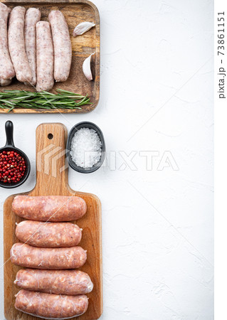 Assorted raw homemade sausages, flat lay with space for text, on white background Assorted raw homemade sausages, flat lay with space for text, on white background 73861151