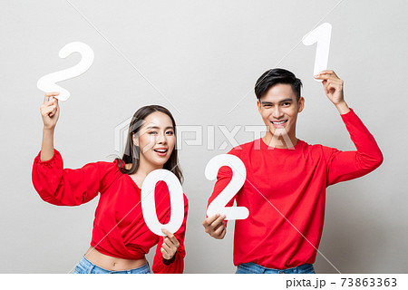 Happy Asian couple smiling and showing number 2021 for new year concept 73863363