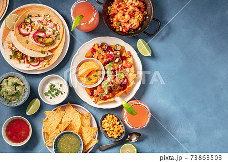Mexican food, an overhead flat lay. Nachos, tacos, and other snacks 73863503