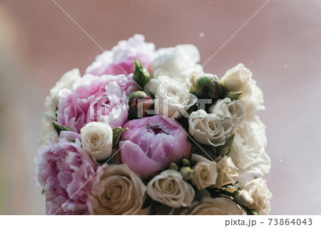 wedding bouquet with white and pink peonies with raindrops 73864043