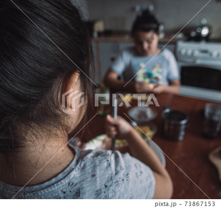 Little kids make traditional cookies. Raw dough and cutters for the holiday cookies on a wooden table background. Preparing cookies. Little kids make traditional cookies. Raw dough and cutters for the holiday cookies on a wooden table background. Preparing cookies. 73867153