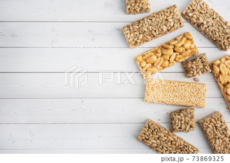 Oriental sweetness of brittle, Kozinaki in sugar glazed peanuts, sunflower seeds and sesame seeds. top view copy space Oriental sweetness of brittle, Kozinaki in sugar glazed peanuts, sunflower seeds and sesame seeds. top view copy space 73869325