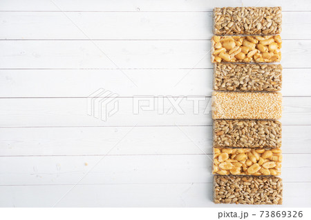 Oriental sweetness of brittle, Kozinaki in sugar glazed peanuts, sunflower seeds and sesame seeds. top view copy space Oriental sweetness of brittle, Kozinaki in sugar glazed peanuts, sunflower seeds and sesame seeds. top view copy space 73869326