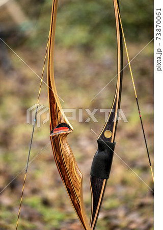 Closeup of two Archery Bows made of wood called Longbow Closeup of two Archery Bows made of wood called Longbow 73870061
