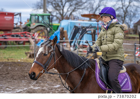 horseback riding at the farmyard in the village horseback riding at the farmyard in the village 73870202