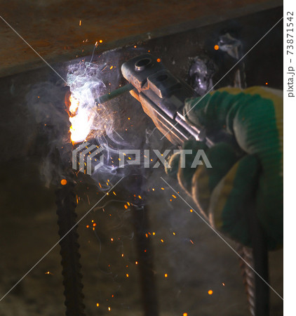 Flame of fire and sparks from welding metal at night Flame of fire and sparks from welding metal at night 73871542